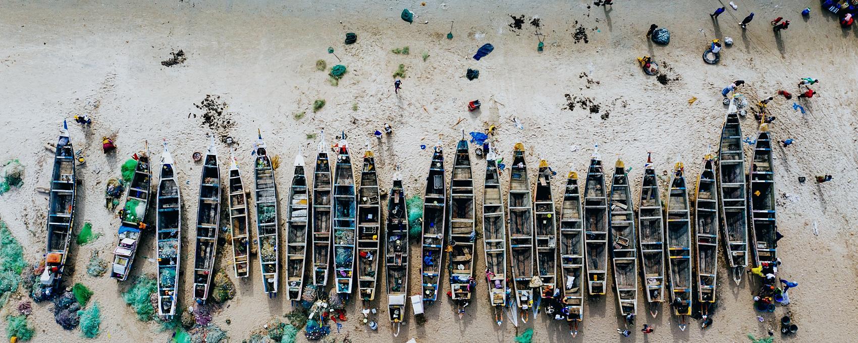 Fishing pirogues drawn up on a West African beach, seen from above